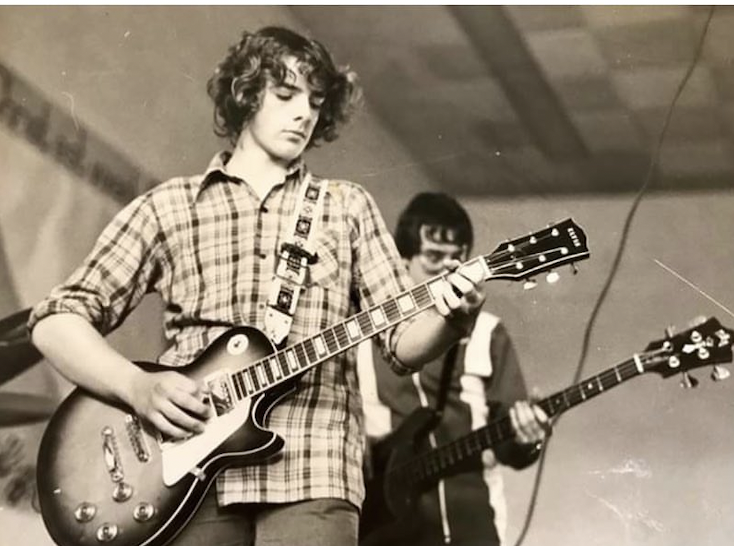 Young Daniel Yvinec playing guitar